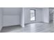 Bright bedroom featuring light gray wood floors, white walls, and a window at 106 Belmont Dr, Canton, GA 30115