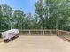 An expansive deck with a wooden railing and grill, ideal for outdoor dining and entertaining in a natural setting at 106 Belmont Dr, Canton, GA 30115