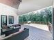 An outdoor living space on a wooden deck with comfortable seating and a view of the surrounding trees at 106 Belmont Dr, Canton, GA 30115