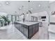 Bright, open kitchen features a large island, hardwood floors, and views into the living area at 106 Belmont Dr, Canton, GA 30115