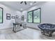 Bright home office with dual windows, modern desk, comfortable chair, and hardwood floors at 106 Belmont Dr, Canton, GA 30115