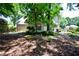 Backyard with trees and shrubbery, creating a private and serene outdoor space at 340 Channings Lake Dr, Lawrenceville, GA 30043