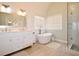 Modern bathroom featuring dual vanity, soaking tub, and glass enclosed shower at 340 Channings Lake Dr, Lawrenceville, GA 30043