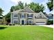 Beautiful two-story home with a well-manicured lawn and attached garage at 340 Channings Lake Dr, Lawrenceville, GA 30043
