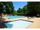 Community hot tub situated next to a large pool surrounded by trees at 340 Channings Lake Dr, Lawrenceville, GA 30043