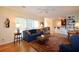 Bright living room with hardwood floors, comfortable seating, and ceiling fan at 340 Channings Lake Dr, Lawrenceville, GA 30043