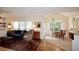 Inviting living room with hardwood floors, large windows, and an open dining area at 340 Channings Lake Dr, Lawrenceville, GA 30043