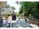 Outdoor patio with furniture, covered grill, and views of the lush, wooded backyard at 340 Channings Lake Dr, Lawrenceville, GA 30043