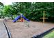 A playground with swings, a slide, and other climbing structures surrounded by lush trees at 340 Channings Lake Dr, Lawrenceville, GA 30043