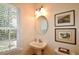 Charming powder room with pedestal sink and natural light from window at 340 Channings Lake Dr, Lawrenceville, GA 30043