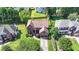 Aerial view of a brick two-story home, manicured landscaping, driveway, green lawn, and mature trees at 350 River Walk Ter, Johns Creek, GA 30024