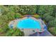 Aerial view of the community swimming pool area with an Olympic-sized swimming pool, lounge chairs, and mature trees at 350 River Walk Ter, Johns Creek, GA 30024