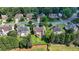 Aerial view of the two-story home, mature trees, and level backyard at 350 River Walk Ter, Johns Creek, GA 30024