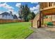 Spacious backyard featuring a well-maintained lawn, a wooden fence and a wooden stairway to the second level deck at 350 River Walk Ter, Johns Creek, GA 30024