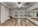 Spacious basement with wood laminate flooring, mirrors, and good lighting; ready for various activities at 350 River Walk Ter, Johns Creek, GA 30024