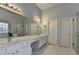 Bright bathroom featuring double vanity, enclosed shower, and natural light at 350 River Walk Ter, Johns Creek, GA 30024