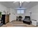 Basement bedroom featuring wood laminate flooring, a window, and a dedicated workspace at 350 River Walk Ter, Johns Creek, GA 30024