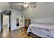 Well-lit bedroom with hardwood floors, en suite bathroom, and doorway to the hallway at 350 River Walk Ter, Johns Creek, GA 30024