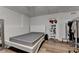 Basement bedroom featuring wood laminate flooring, a bed, closet and exposed clothing rack at 350 River Walk Ter, Johns Creek, GA 30024