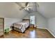 Spacious bedroom featuring hardwood floors, ceiling fan, and natural light from the window at 350 River Walk Ter, Johns Creek, GA 30024