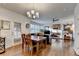 Open dining area with hardwood floors and view of the living room with fireplace at 350 River Walk Ter, Johns Creek, GA 30024