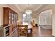 Dining room with tray ceilings, hardwood floors, and adjacent butler's pantry at 350 River Walk Ter, Johns Creek, GA 30024