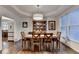 Formal dining room with hardwood floors, elegant chandelier, and ample natural light at 350 River Walk Ter, Johns Creek, GA 30024