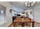 Dining area with hardwood floors, natural light, and views of the living room and backyard at 350 River Walk Ter, Johns Creek, GA 30024