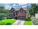 Charming brick two-story home with two-car garage and well-manicured front lawn at 350 River Walk Ter, Johns Creek, GA 30024