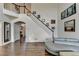 Bright foyer with hardwood floors, staircase, and neutral decor at 350 River Walk Ter, Johns Creek, GA 30024