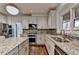 Kitchen features granite countertops, stainless steel appliances and tile backsplash at 350 River Walk Ter, Johns Creek, GA 30024