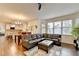 Spacious living room with a large sectional sofa and open access to the modern kitchen at 350 River Walk Ter, Johns Creek, GA 30024