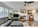 Sunlit living room features bay windows, a cozy fireplace, and hardwood floors at 350 River Walk Ter, Johns Creek, GA 30024