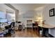 Bright home office with hardwood floors, neutral walls, and multiple workspaces at 350 River Walk Ter, Johns Creek, GA 30024