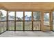 Enclosed porch area featuring wood floors, a wood ceiling, many windows and an exterior view to the backyard at 350 River Walk Ter, Johns Creek, GA 30024