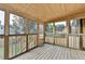 Enclosed porch area featuring wood floors, a wood ceiling, many windows and an exterior view to the backyard at 350 River Walk Ter, Johns Creek, GA 30024