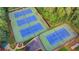 Aerial view of community tennis courts with well maintained blue courts at 350 River Walk Ter, Johns Creek, GA 30024