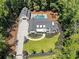 Aerial view showcasing a home with pool, playground, detached garage, four-car garage and lush landscaping at 504 Trinity Church Rd, Canton, GA 30115