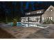 Evening view of the backyard featuring a pool, outdoor living spaces, and mature trees creating a private oasis at 504 Trinity Church Rd, Canton, GA 30115
