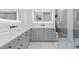 Modern bathroom with double vanity with black fixtures, large mirrors and access to a glass shower at 504 Trinity Church Rd, Canton, GA 30115