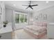 Bright bedroom with a floral bedspread, ceiling fan and neutral decor and light gray wall paint at 504 Trinity Church Rd, Canton, GA 30115