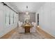 Elegant dining room with white walls, hardwood floors, seating for eight, and a chandelier at 504 Trinity Church Rd, Canton, GA 30115