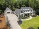 Aerial view of a beautiful two-story home with manicured lawn, a long driveway, and three-car garage at 504 Trinity Church Rd, Canton, GA 30115