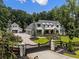 Beautiful home with a gated entrance, lush green lawn and four-car garage, and detached additional garage at 504 Trinity Church Rd, Canton, GA 30115
