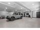 This spotless garage boasts an epoxy floor, ceiling fans and lights, and a luxury car at 504 Trinity Church Rd, Canton, GA 30115