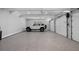 Spacious garage with epoxy flooring, offering ample space for parking and storage with multiple overhead doors at 504 Trinity Church Rd, Canton, GA 30115