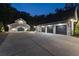 Detached garage and attached four-car garage with long driveway, and white exteriors with black doors at 504 Trinity Church Rd, Canton, GA 30115