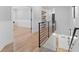 Bright hallway features wood floors, black iron railing, and open shelving at 504 Trinity Church Rd, Canton, GA 30115