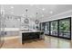 Spacious kitchen with an island, bar seating, and sliding doors to an outdoor dining area at 504 Trinity Church Rd, Canton, GA 30115