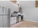 Modern kitchen with stainless steel appliances, white cabinets, hardwood floors, and wooden beam ceiling at 504 Trinity Church Rd, Canton, GA 30115